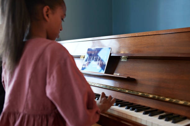 grandmother-teaching-grand-piano-to-granddaughter